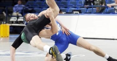 Two collegiate wrestlers, one upended, asics wrestling shoes