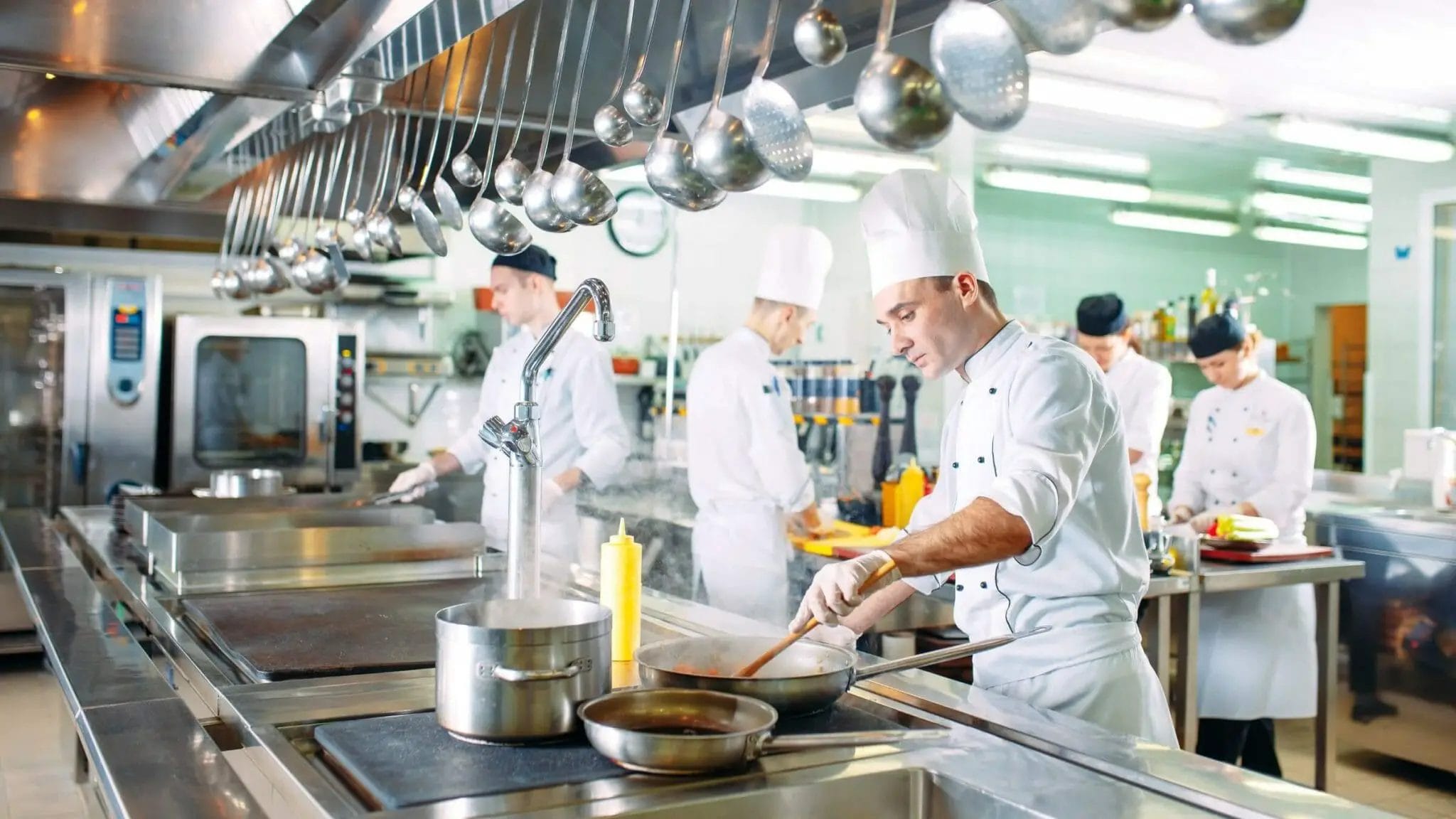 Commercial kitchen with multiple people cooking