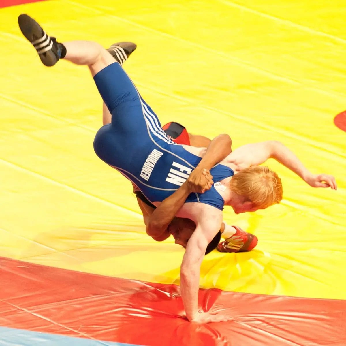 Olympic wrestling image of Finland wrestler wearing adidas shoes.