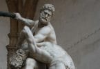 Wrestling history in ancient Greece seen in statue of a man wrestling with a centaur.