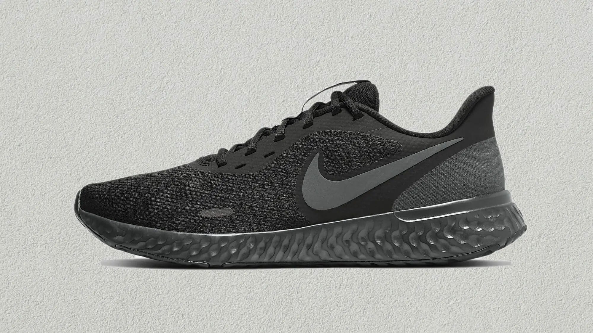All black Nike Revolution 5 running shoe in profile