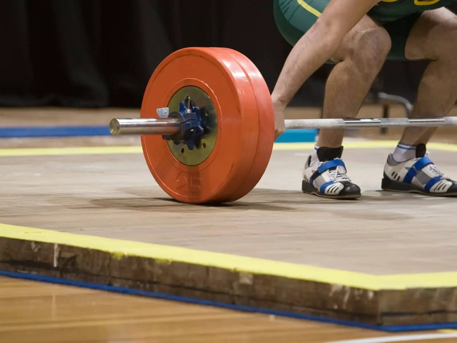 Olympic weight lifter wearing adidas adistar shoes preparing for clean and jerk.