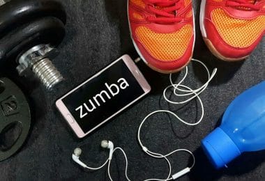Zumba shoes featured with blue water bottle and iPhone and dumbbell